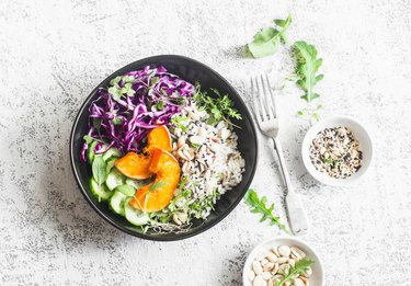 Wild rice, roasted pumpkin, red cabbage buddha bowl. Vegetarian food concept. On a light background, top view