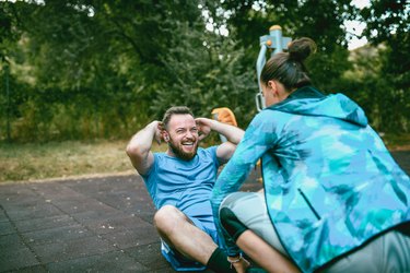 Female Fitness Instructor Working Out With Client