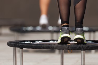 Fitness women jumping on small trampolines