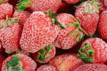 Frozen strawberries with frost on them