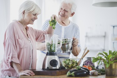Happy older couple on a diabetes diet preparing a smoothie at home