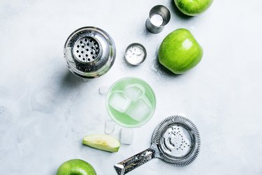 Summer alcoholic cocktail with green apple, vermouth and ice