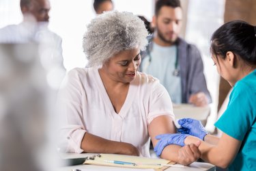 Senior woman prepares to receive flu shot