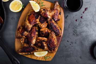 Roast chicken wings on cutting board