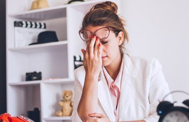 Young and beautiful businesswoman tired from work in the office