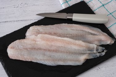 Filleted Scottish Haddock on a Carving Slate and Ready for the Oven.