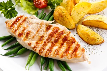 Grilled chicken breast, French fries and vegetables