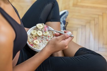 Young woman eating a oatmeal after a workout