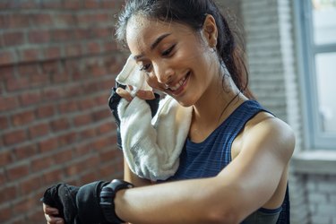 Asian girl exercising in gym she tired and She has sweat on her face.