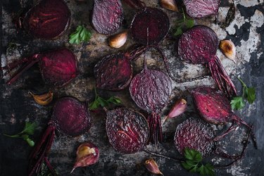 Roasted beetroots and garlic on baking sheet