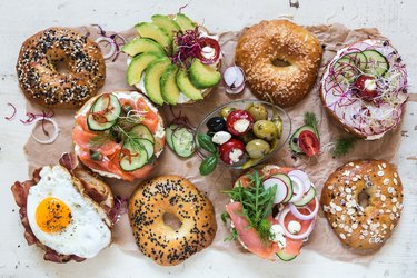 Top view of a variety of bagels with healthy toppings, as an example of food on a reactive hypoglycemia diet plan