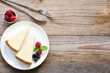 New York cheesecake or classic cheesecake with fresh berries on white plate