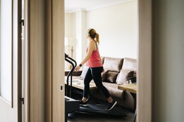 woman exercising on a treadmill at home