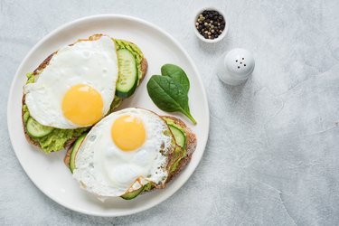 Two toasts with avocado, cucumber and egg