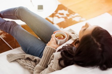 Woman relaxing at home with a cup of tea