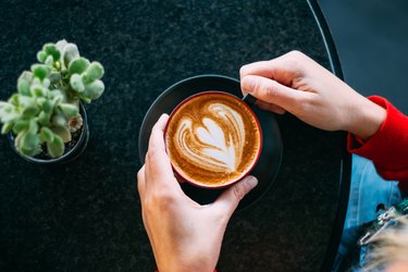 Top View Woman Hand Holding Latte