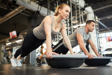 Couple Doing Balance Exercises in Gym