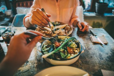 couple sharing health bowl of vegetables