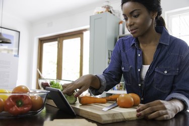 Woman scrolling through her digital tablet.