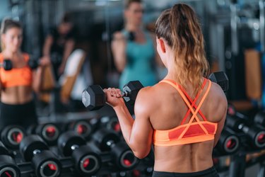 Friends Exercising with Weights in the Gym