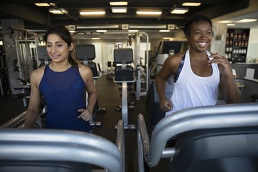 Women using treadmills in gym