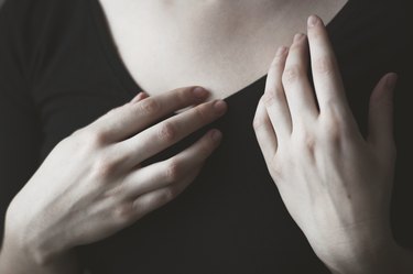 Close-up of woman's hands in front of her chest