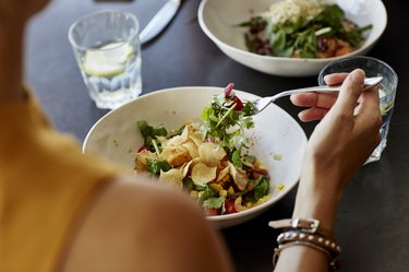 Woman eating a salad in a restaurant