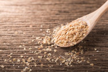Wheat germ plant-based protein foods on wood spoon