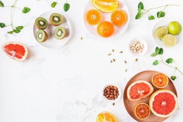 Colorful fresh fruit on white table. Flat lay, top view