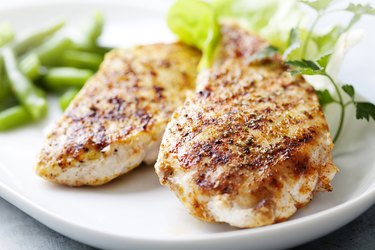 Ceramic plate with grilled chicken breast and green beans