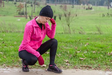 Young female athlete feeling lightheaded or with headache