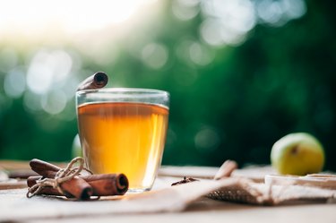 Hot glass mug of cinnamon tea