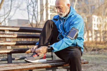 older man tying sneakers to exercise