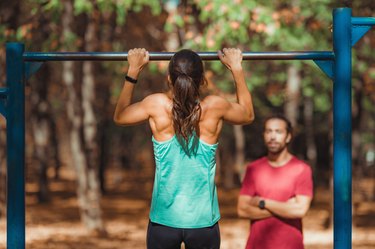 Woman doing pull-ups in the park