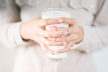 Teenager holding fresh milk and drink