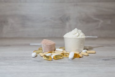 Two scoops of protein powder on a grey wooden table