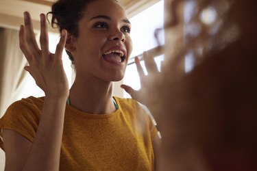 Close-up young women talking, while sitting in bunk bed