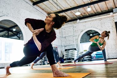 Women in a yoga class at an industrial gym