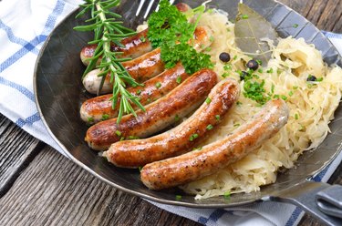 Sausages are served together with sauerkraut on a metal pan