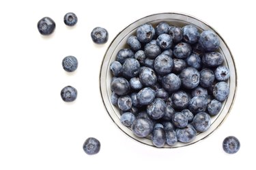 Directly Above Shot Of Blueberries Over White Background