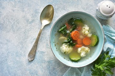 Vegetable soup with spinach, zucchini, carrot and cauliflower