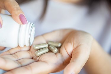 close view of a hand holding tyrosine capsules