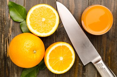 Close-Up Of Oranges And Juice On Table