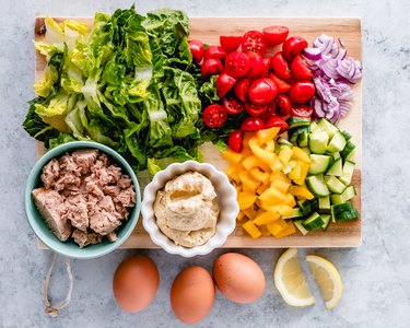 Egg and tuna salad ingredients on a chopping board