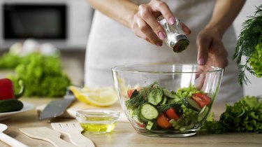 Adding salt tovegetable salad glass bowl for low sodium diet