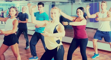 Adult people learning zumba steps