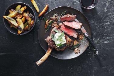 Tomahawk beef steak with mushrooms, burrata and sage potato wedges