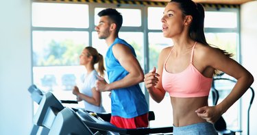 Young attractive woman doing cardio training in gym