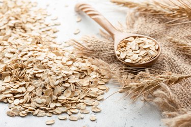 Rolled oats, ears of wheat and wooden spoon