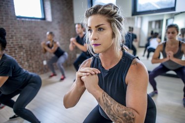 Diverse fitness class doing squats